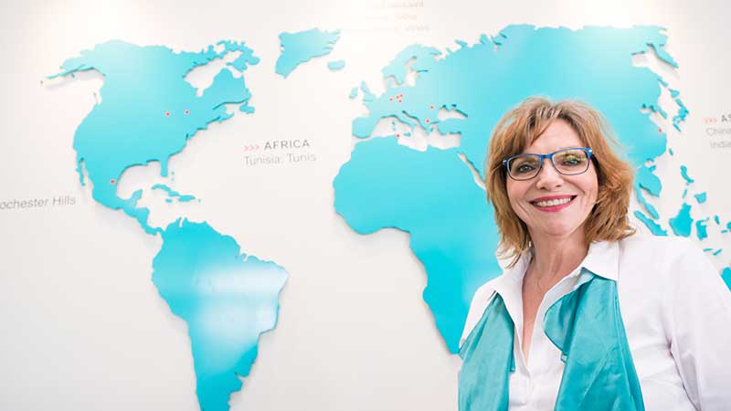 Woman in front of Marquardt global map